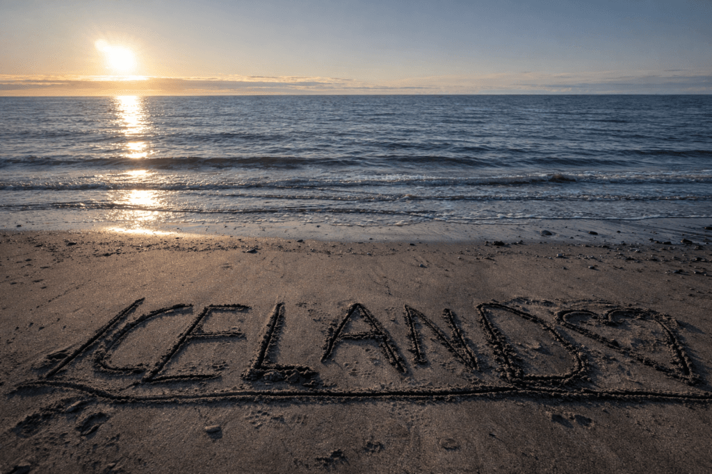 Iceland sandy beach with ocean waves and coastal landscape