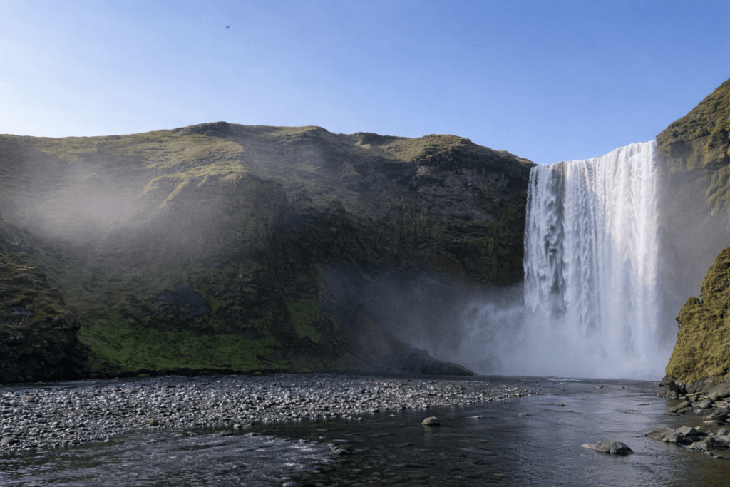 Skogafoss waterfall in South Iceland with dramatic cliffs and mist